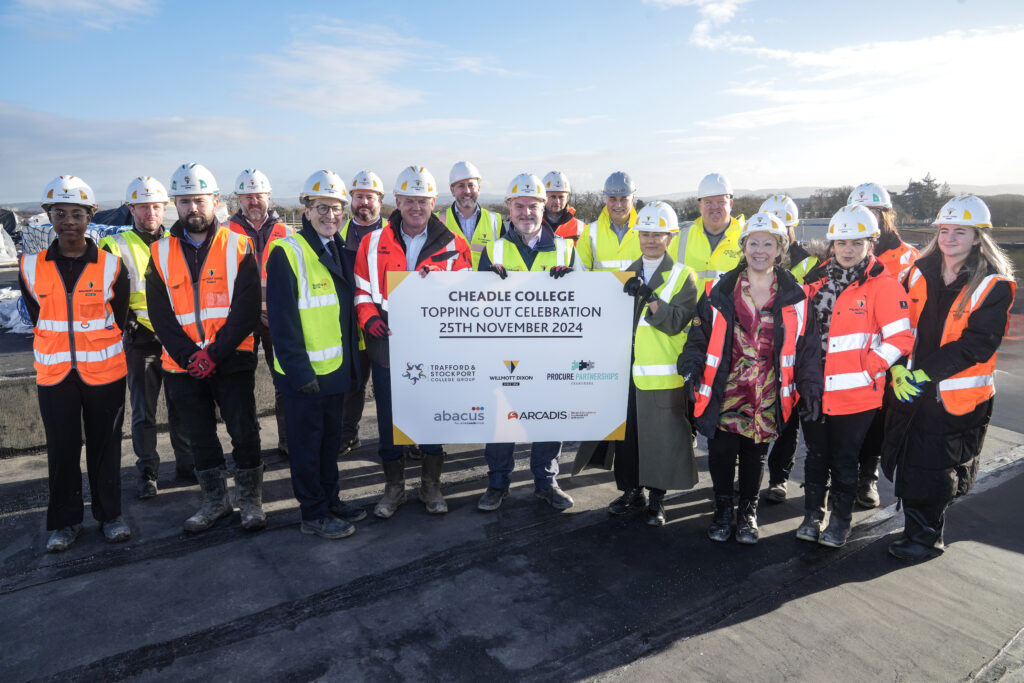 Picture shows: Students and staff from Cheadle College with the Willmott Dixon team celebrating the topping-out milestone at the new campus site.