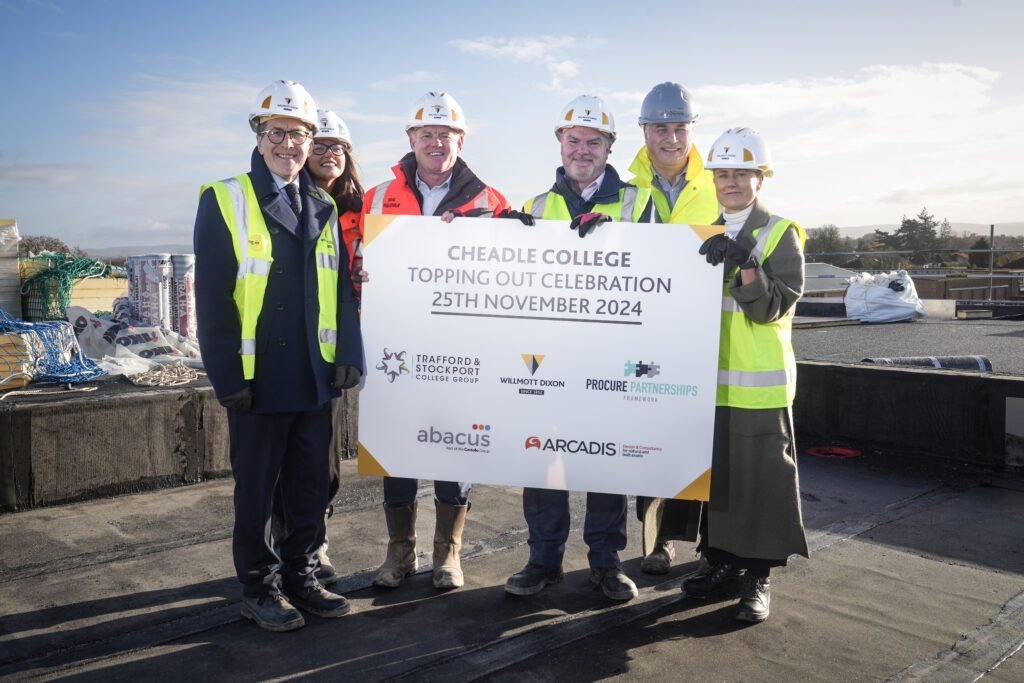 Picture shows: Students and staff from Cheadle College with the Willmott Dixon team celebrating the topping-out milestone at the new campus site.