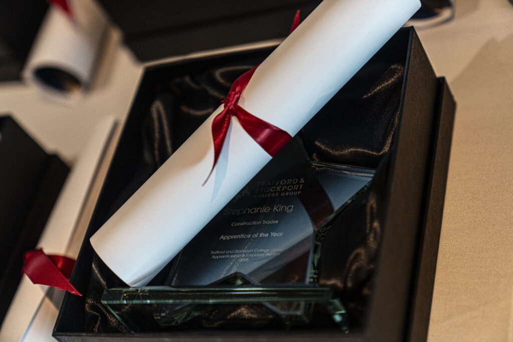 Award in a box with a rolled up certificate placed on top
